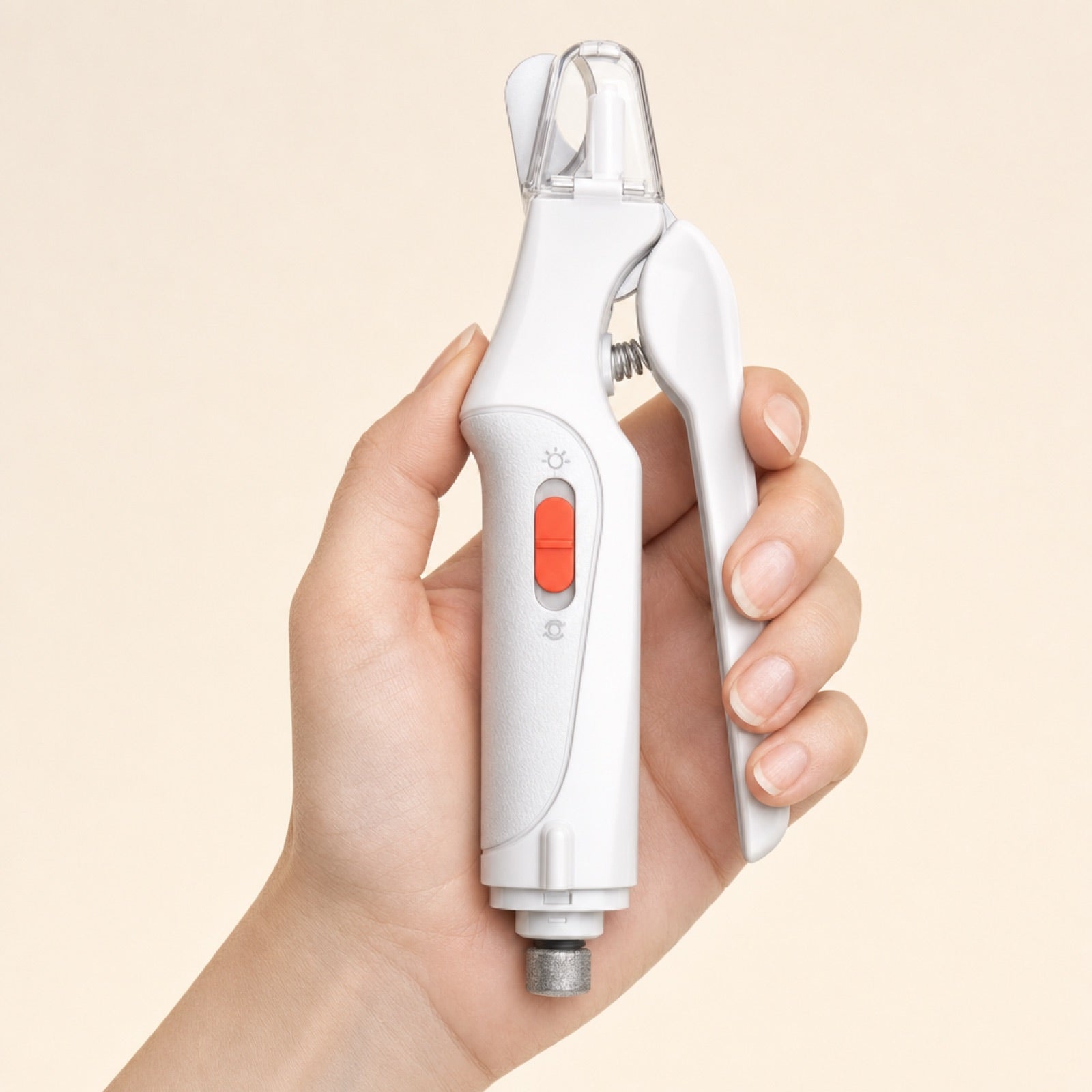 Pet nail clipper held in an adult hand, showing scale